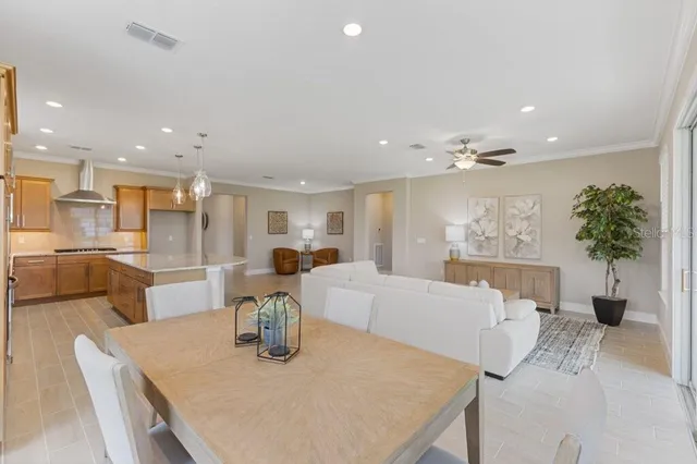 a living room with kitchen island furniture and a chandelier