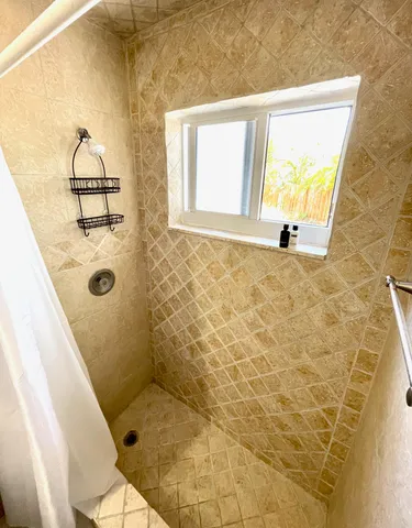 a bathroom with a granite countertop shower and a sink