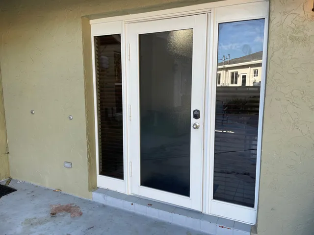 a view of a hallway with wooden floor and a living room