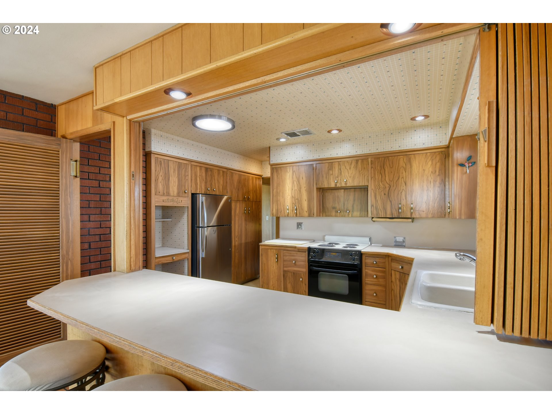 405 Northwest Johns Lane Pendleton, OR 97801 - Photo 15 of 48 a kitchen with stainless steel appliances kitchen island granite countertop a refrigerator and a sink