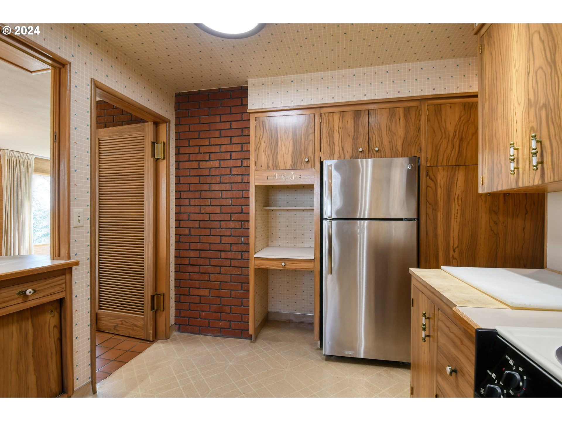 405 Northwest Johns Lane Pendleton, OR 97801 - Photo 18 of 48 a kitchen with refrigerator and cabinets