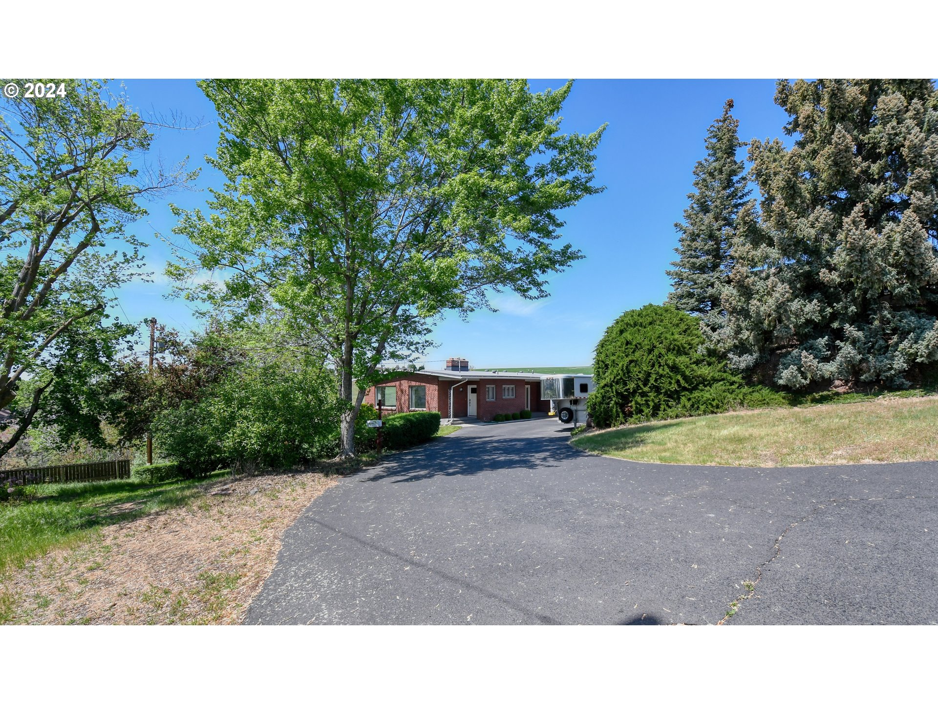 405 Northwest Johns Lane Pendleton, OR 97801 - Photo 2 of 48 a backyard of a house with a yard and garage