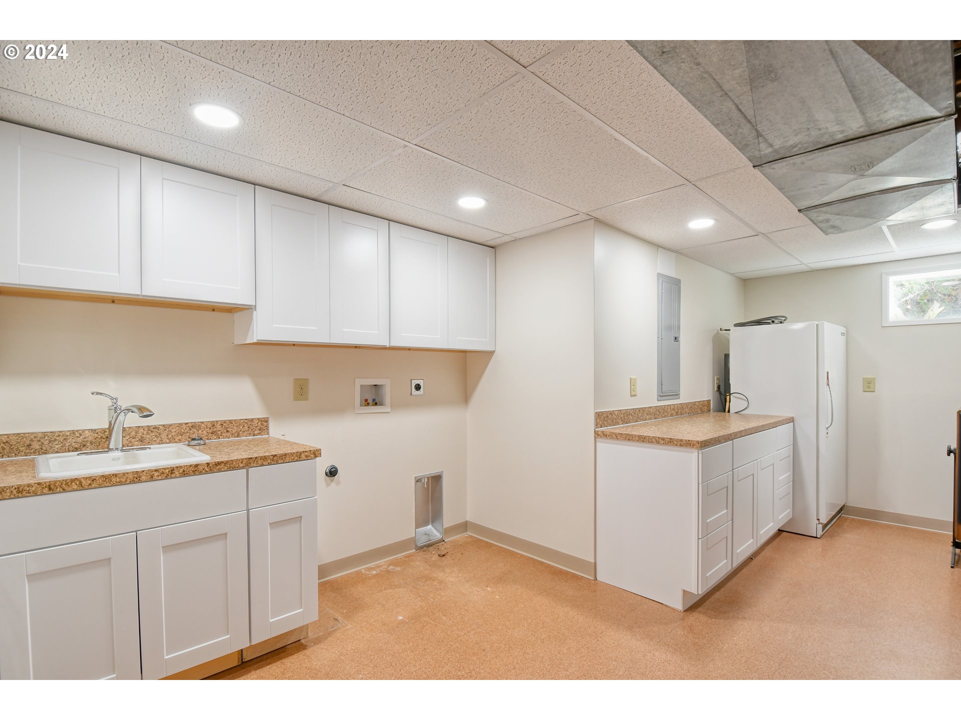 405 Northwest Johns Lane Pendleton, OR 97801 - Photo 35 of 48 a kitchen with a sink a stove a refrigerator and white cabinets