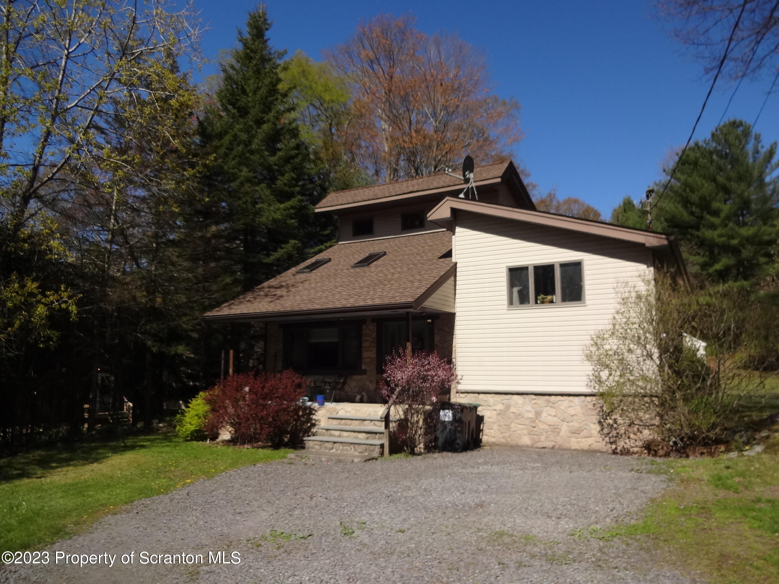 a view of a house with a patio and a yard