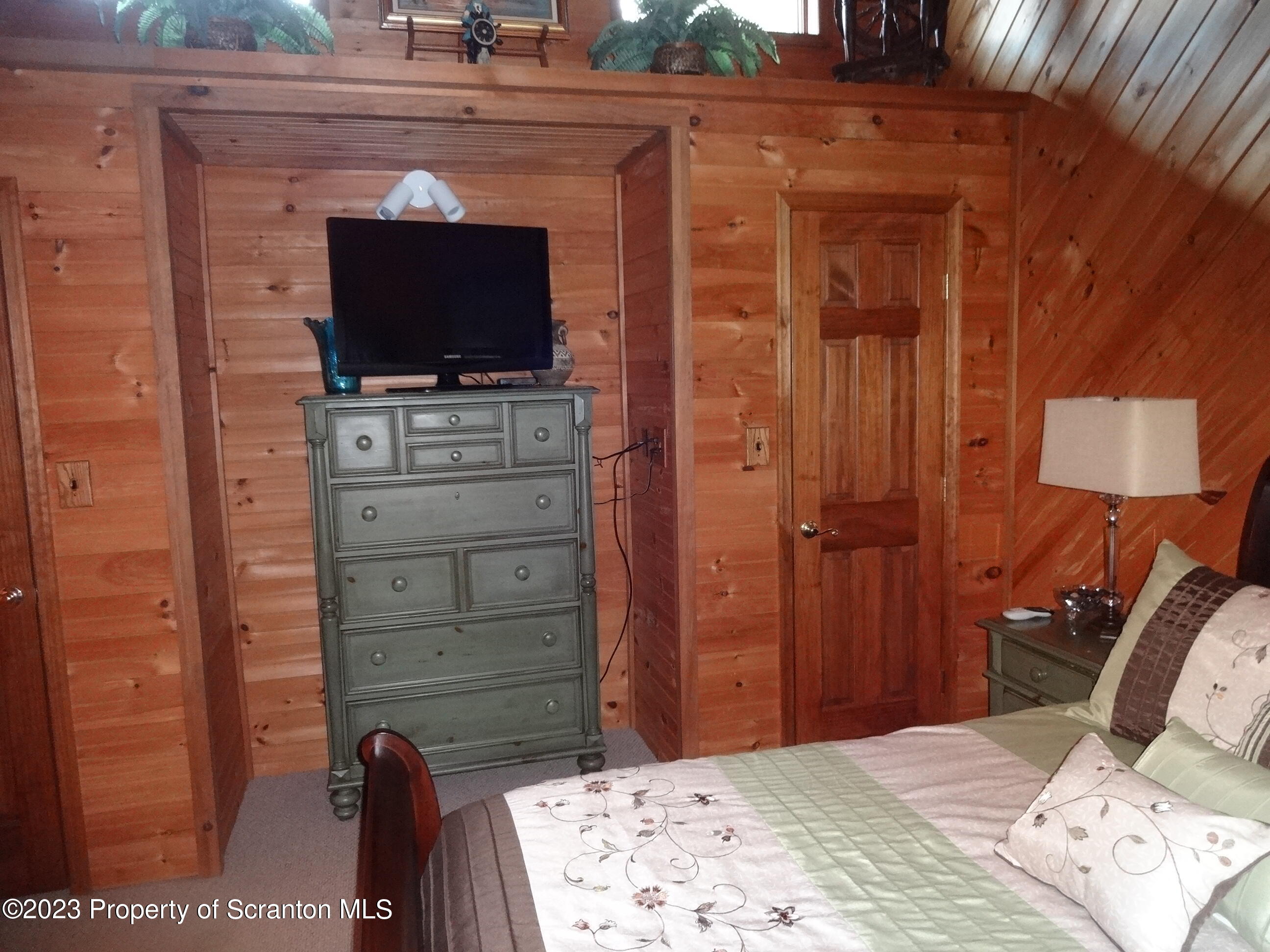 15 Buck River Road Thornhurst, PA 18424 - Photo 22 of 38 a room with a bed and a television