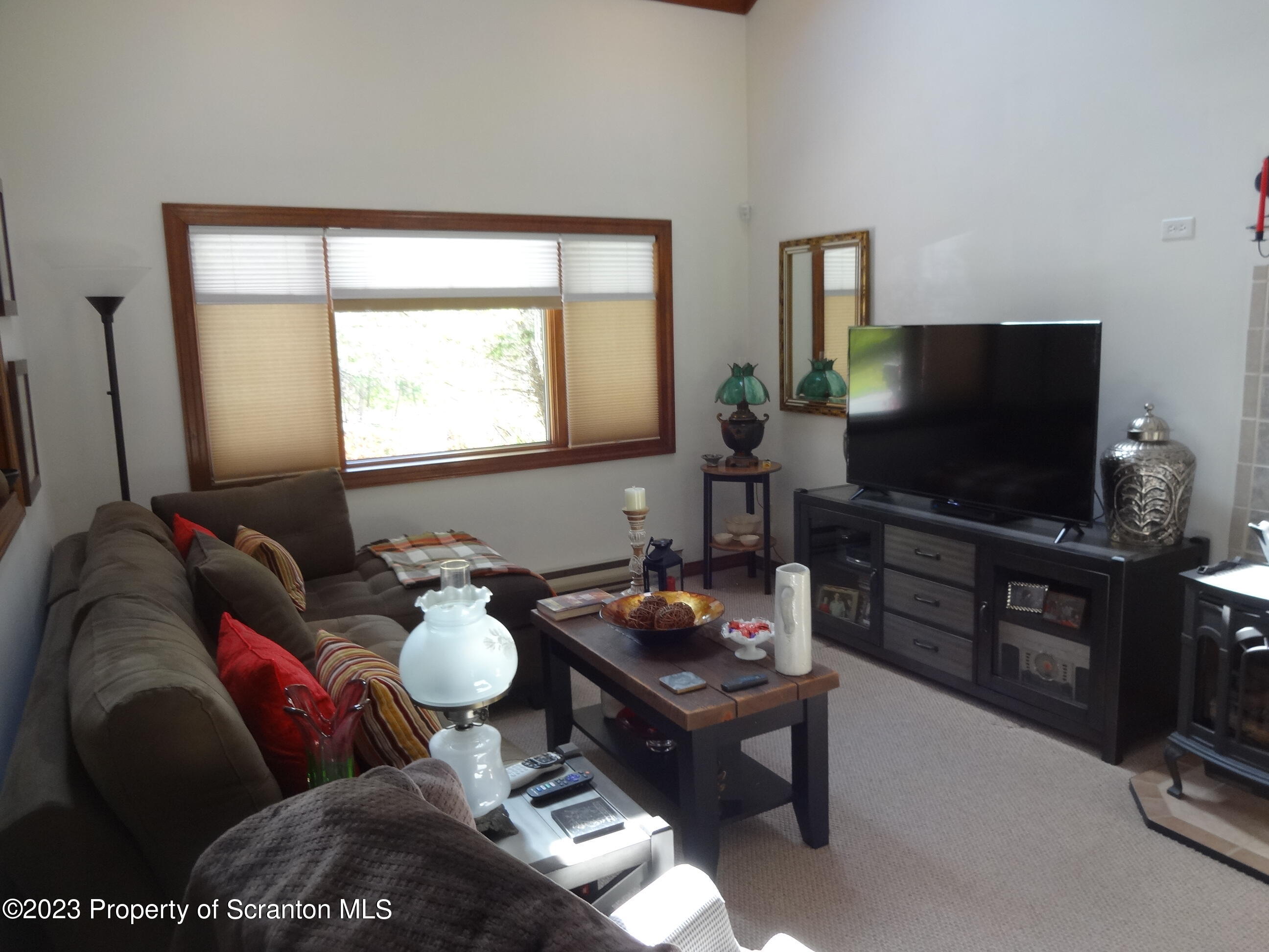 15 Buck River Road Thornhurst, PA 18424 - Photo 3 of 38 a living room with furniture and a flat screen tv