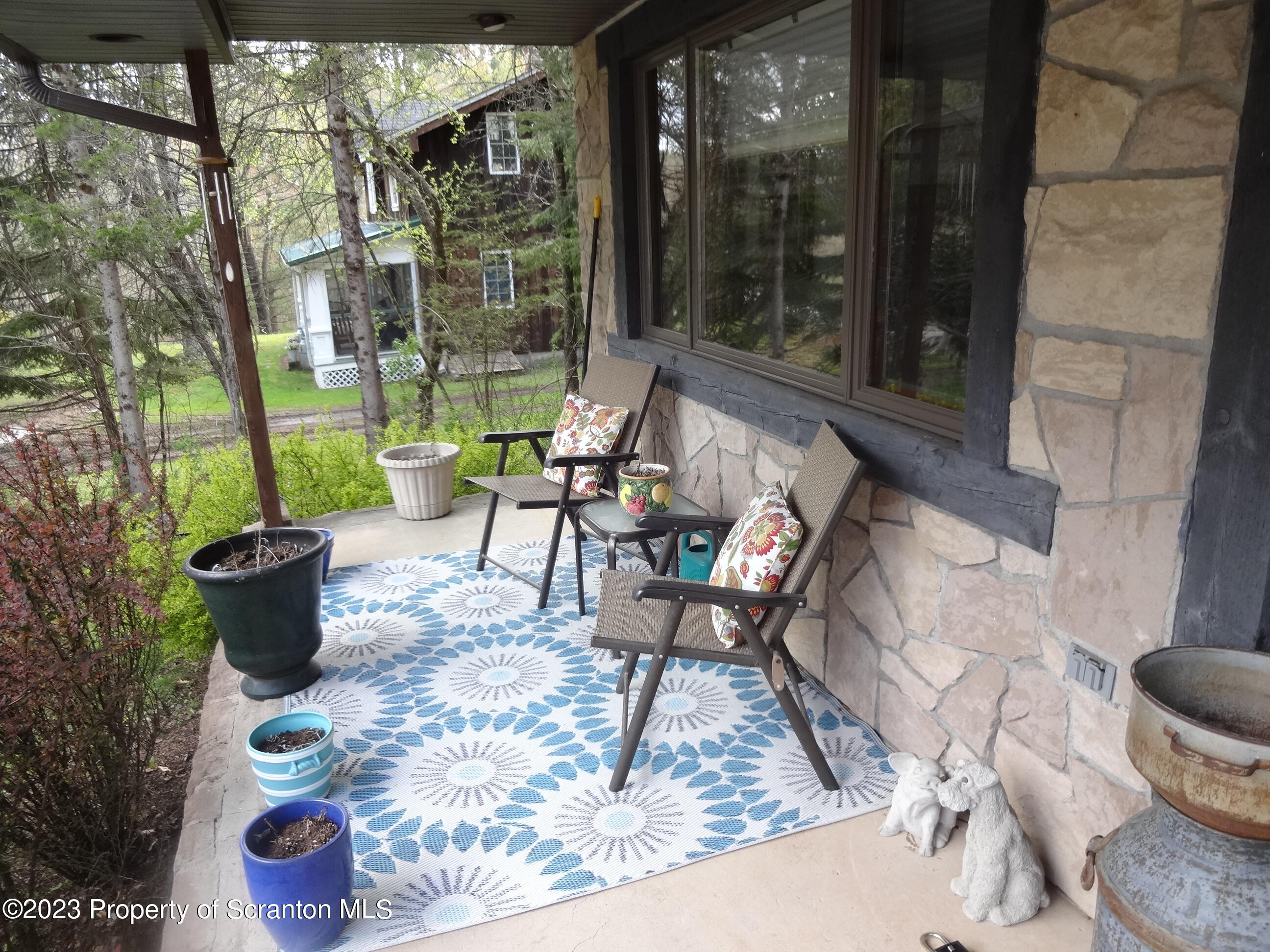 15 Buck River Road Thornhurst, PA 18424 - Photo 36 of 38 a building outdoor space with patio furniture and potted plants