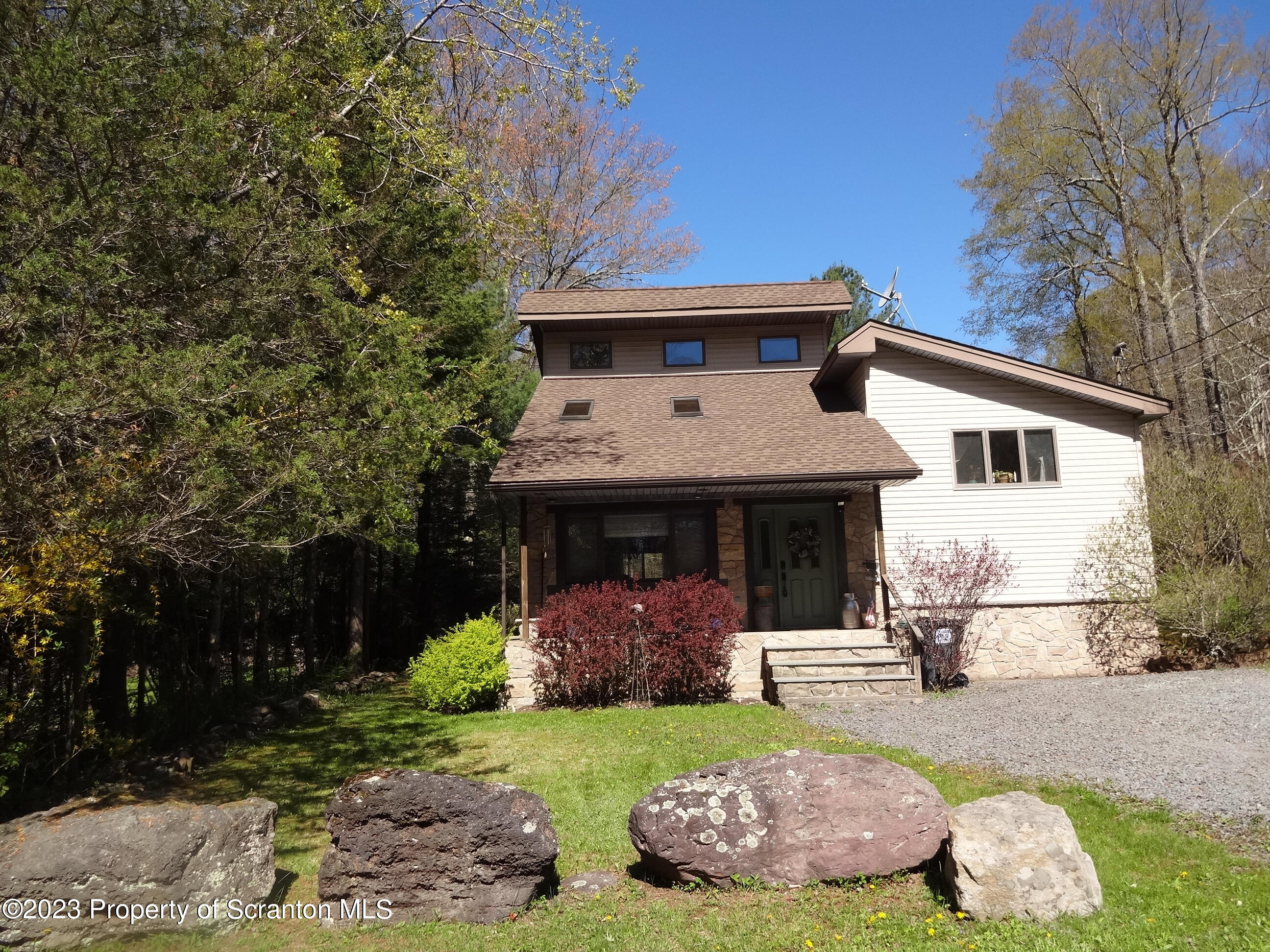 15 Buck River Road Thornhurst, PA 18424 - Photo 38 of 38 a front view of a house with a yard and garage