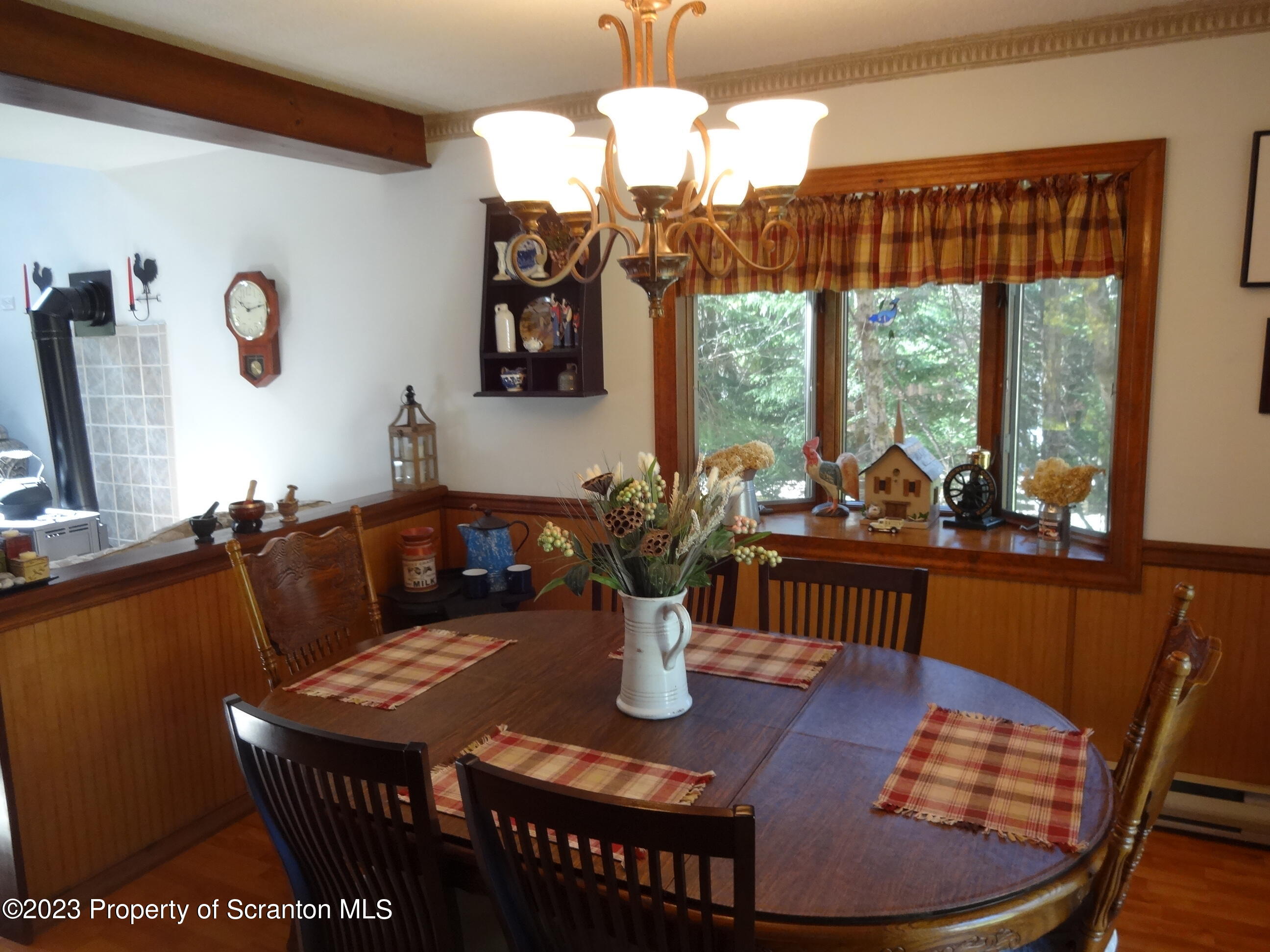 15 Buck River Road Thornhurst, PA 18424 - Photo 8 of 38 a view of a dining room with furniture a chandelier and large windows