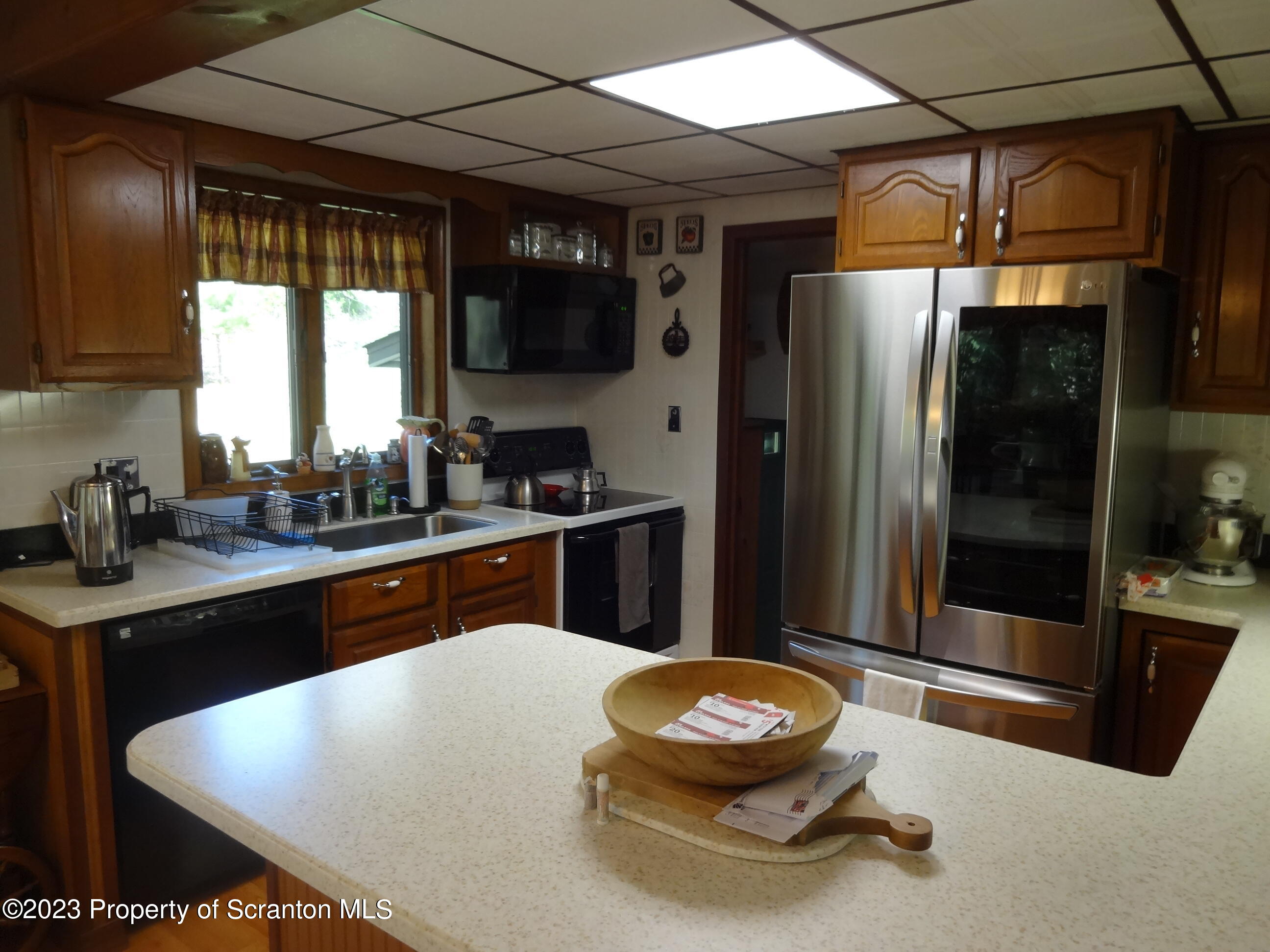 15 Buck River Road Thornhurst, PA 18424 - Photo 9 of 38 a kitchen with a sink a refrigerator and window