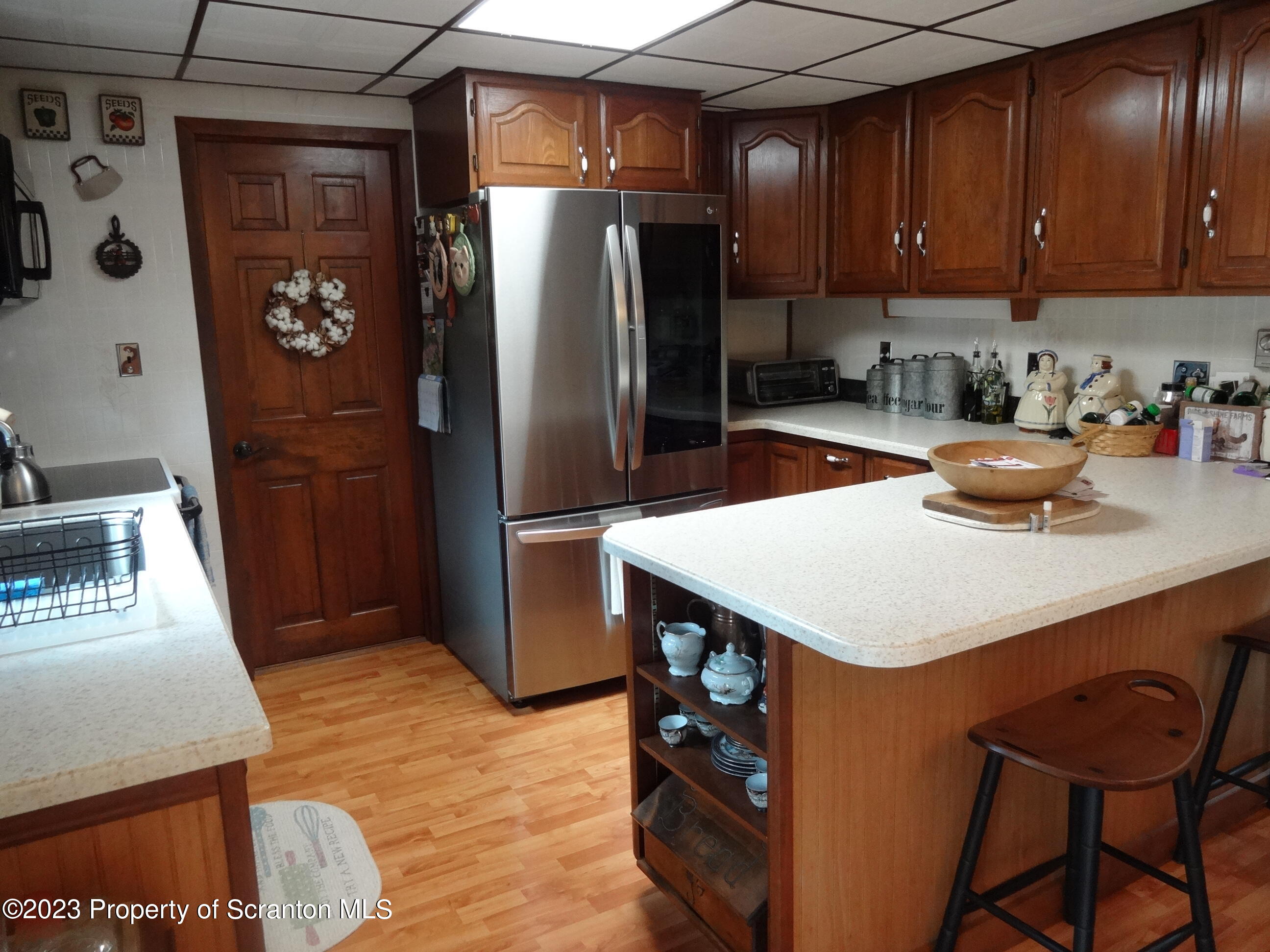 15 Buck River Road Thornhurst, PA 18424 - Photo 10 of 38 a kitchen with stainless steel appliances a sink a refrigerator and wooden cabinets