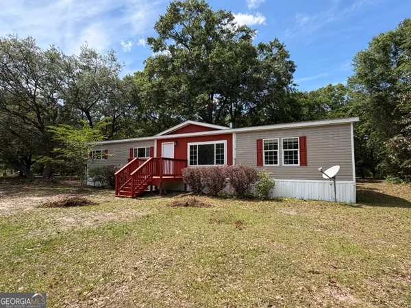 a view of house with backyard
