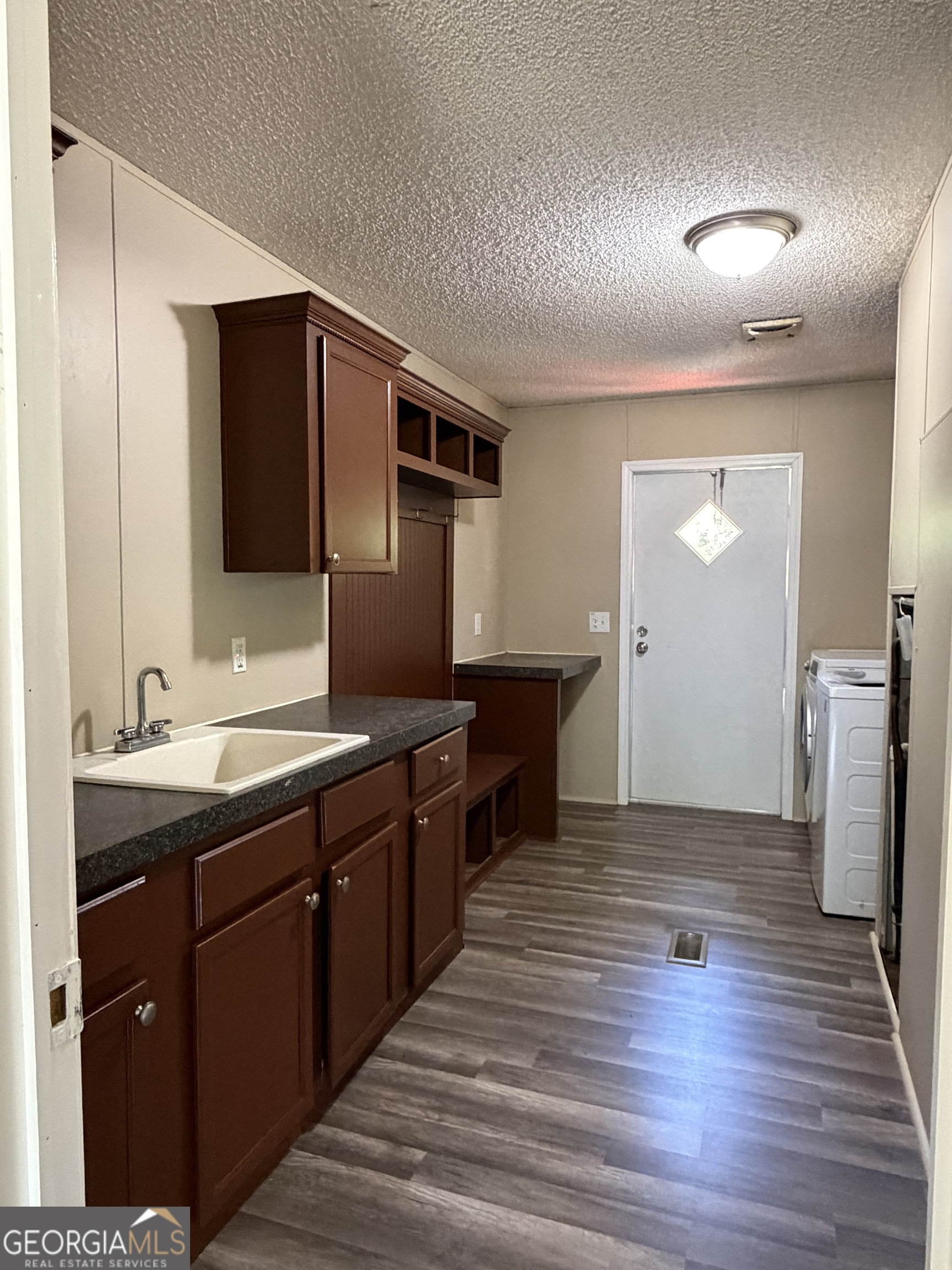 2 Buckboard Trail Jesup, GA 31546 - Photo 12 of 39 a kitchen with stainless steel appliances granite countertop a sink and wooden cabinets
