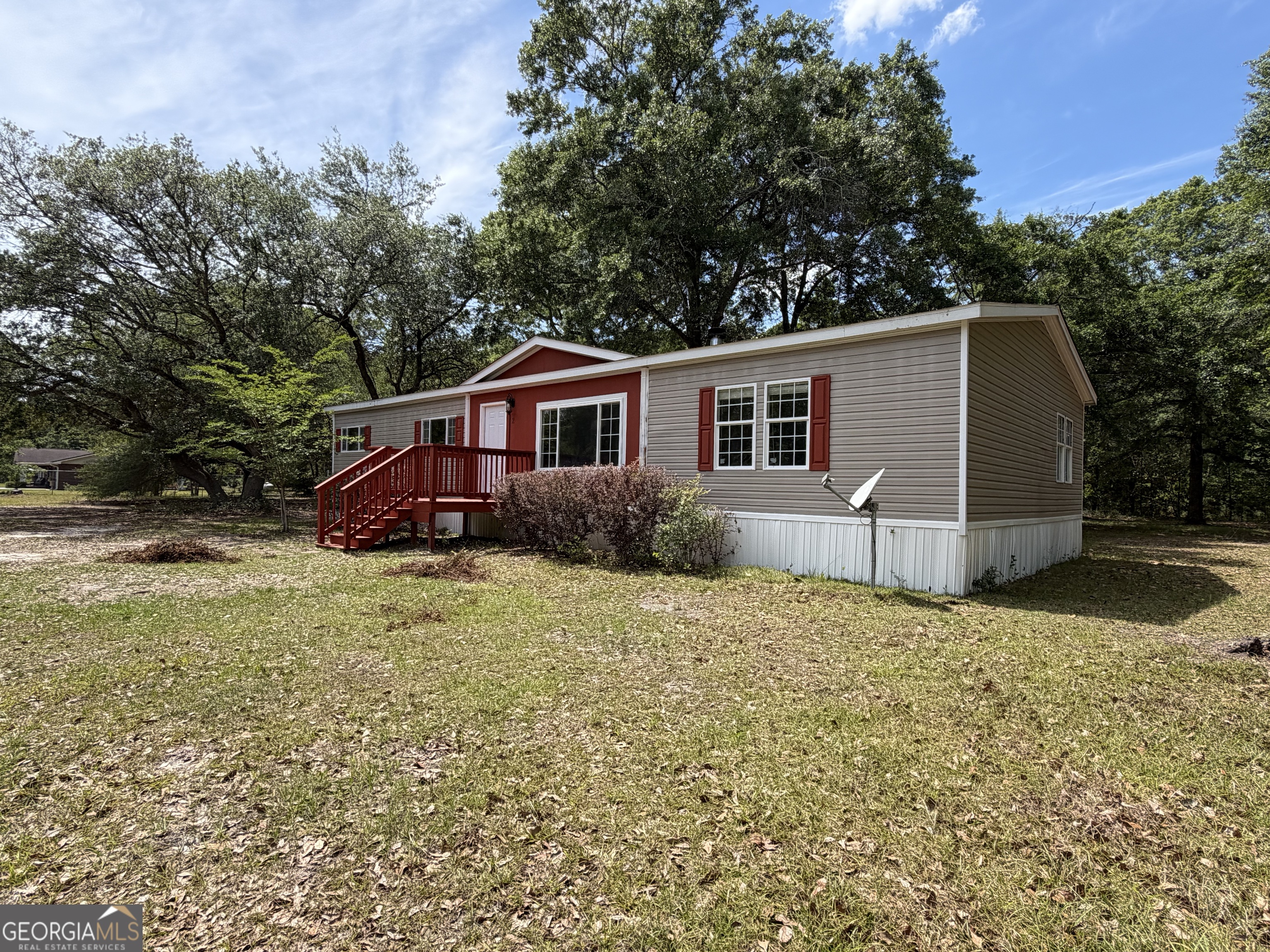 2 Buckboard Trail Jesup, GA 31546 - Photo 2 of 39 a house with trees in the background