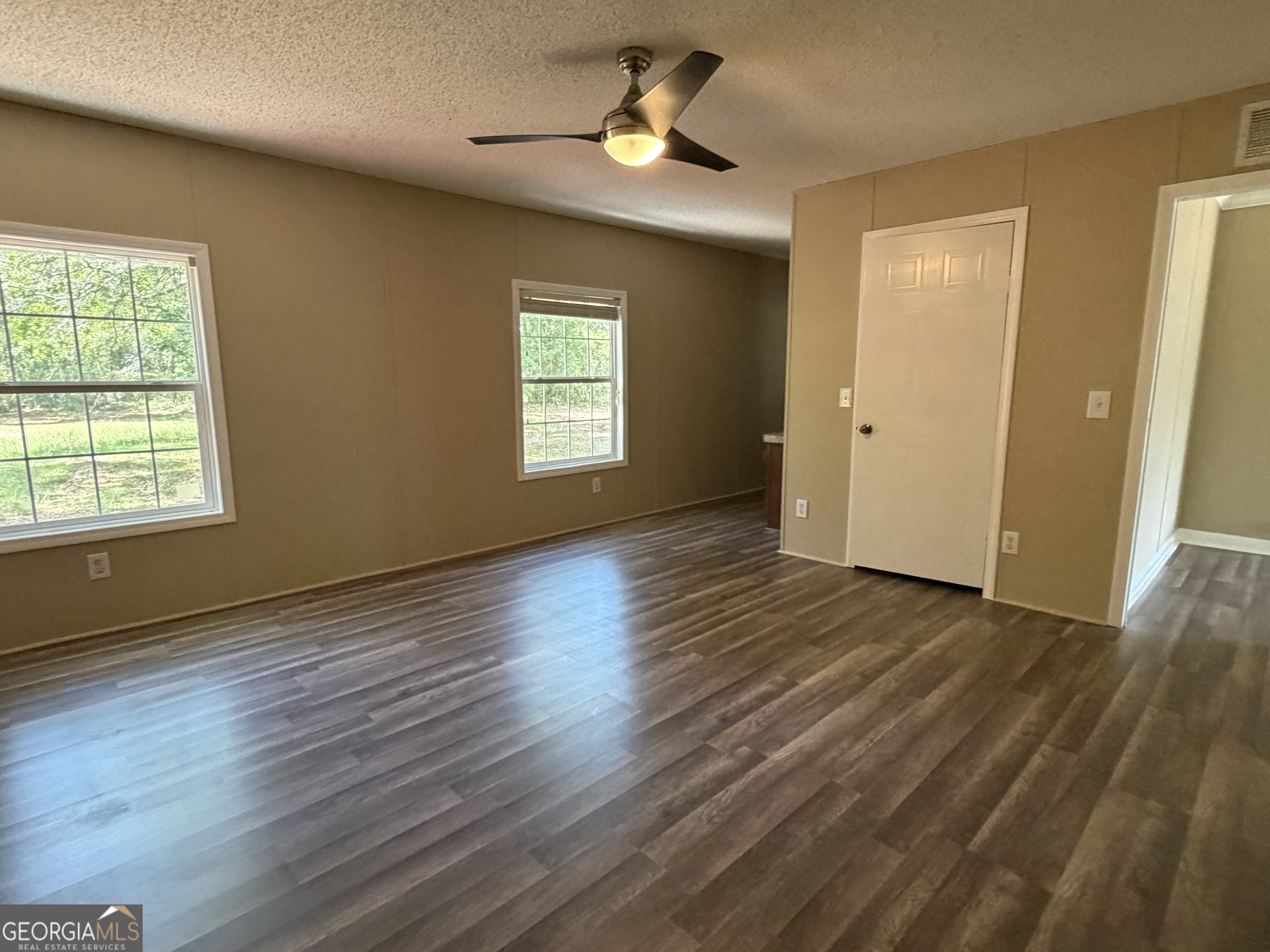 2 Buckboard Trail Jesup, GA 31546 - Photo 21 of 39 a view of an empty room with wooden floor and a window