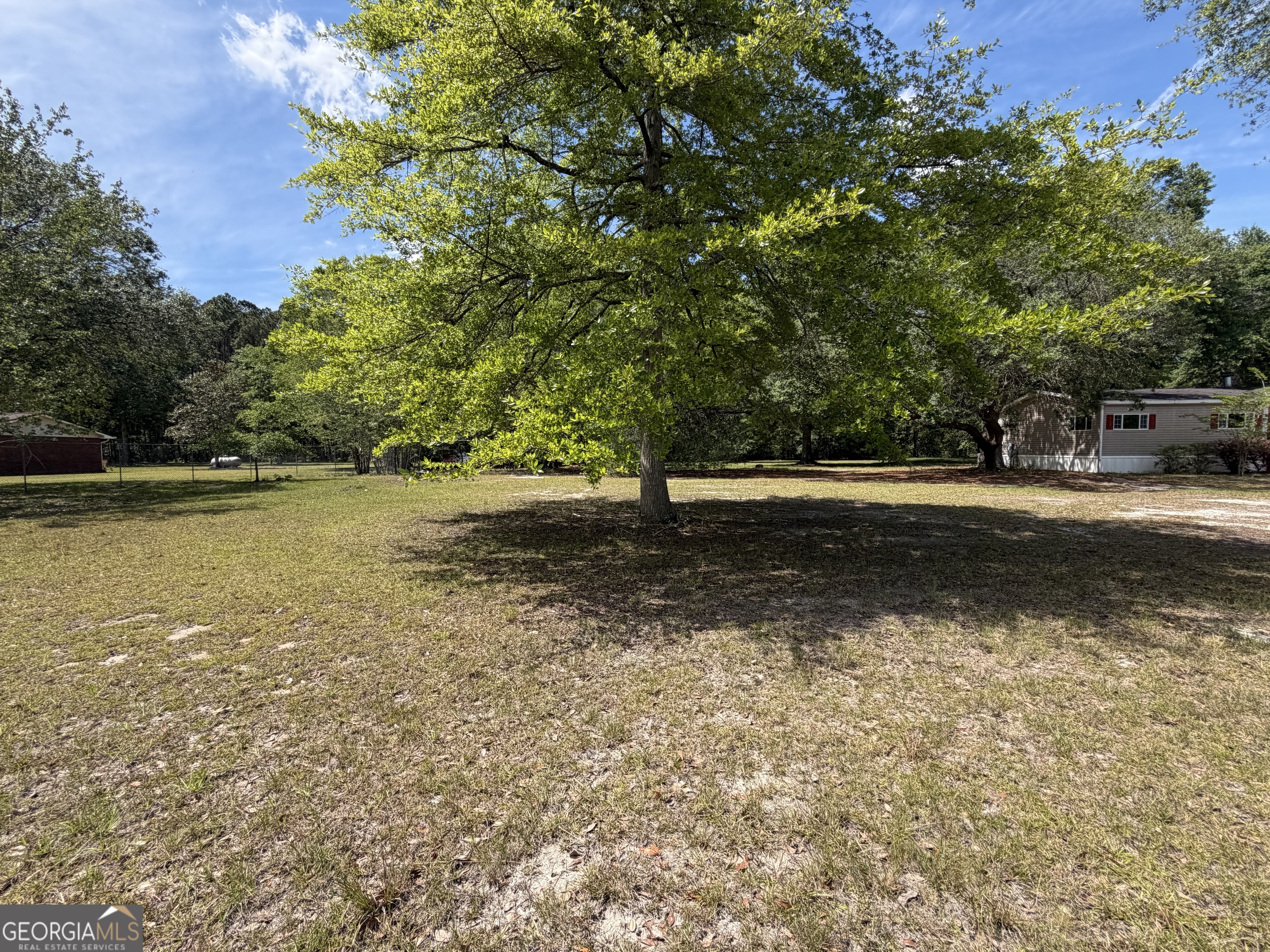 2 Buckboard Trail Jesup, GA 31546 - Photo 26 of 39 a view of outdoor space with swimming pool and trees in the background