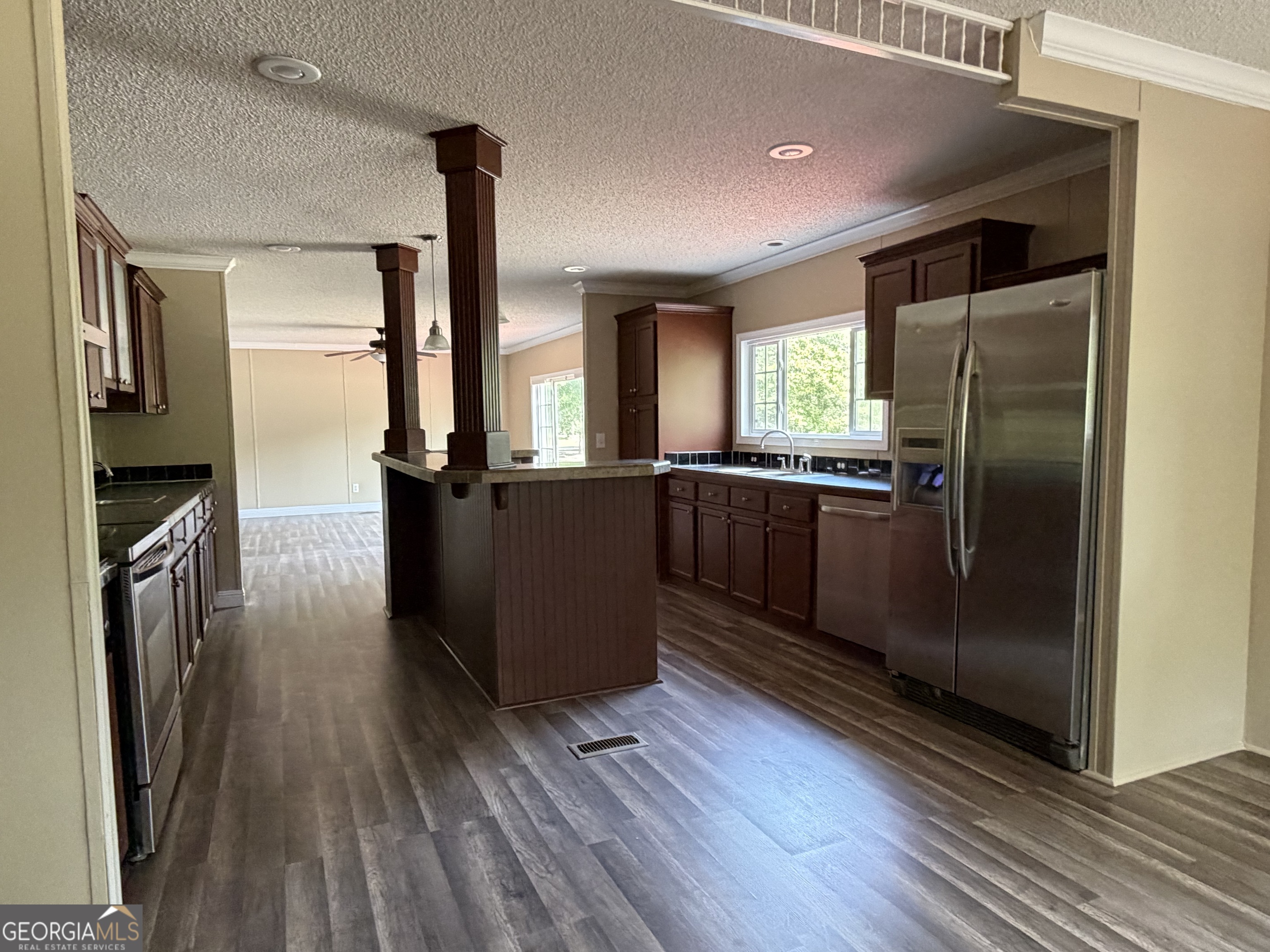 2 Buckboard Trail Jesup, GA 31546 - Photo 8 of 39 a kitchen with stainless steel appliances granite countertop a refrigerator a sink and wooden floors