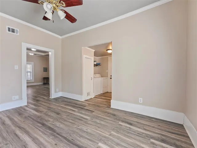 a view of an empty room and wooden floor