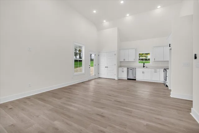 a view of a kitchen with refrigerator and window