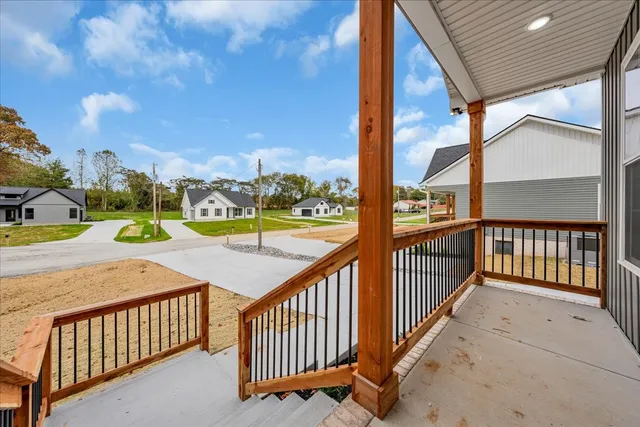a view of a porch with wooden floor and fence