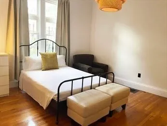 a bedroom with a bed and window