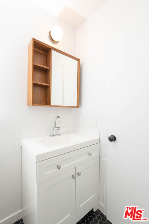 5935 Chula Vista Way, Unit 103 Los Angeles, CA 90068 - Photo 6 of 12 a bathroom with a sink and a mirror