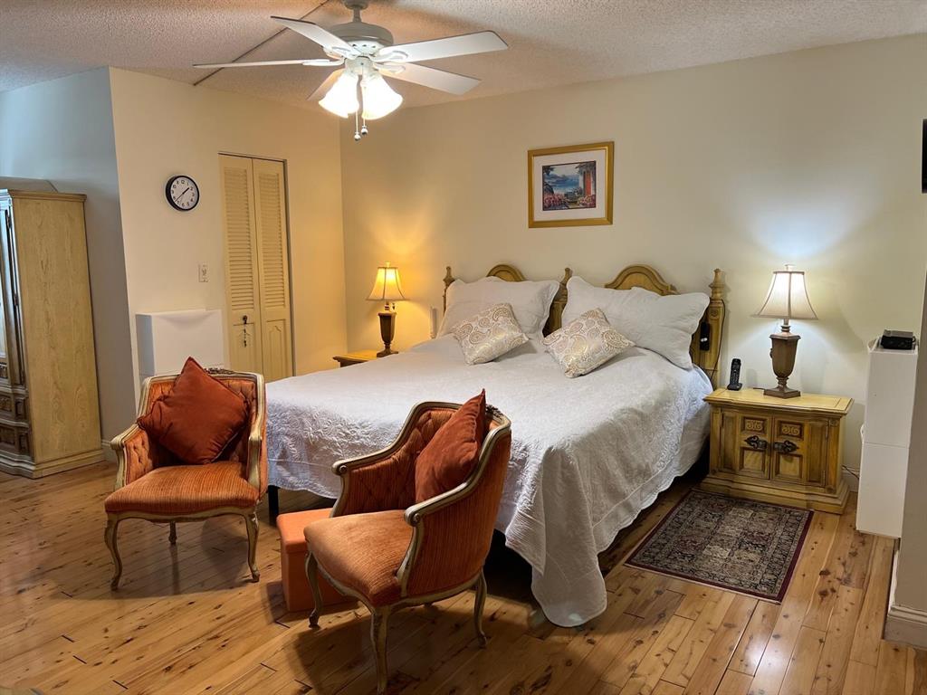 3910 Inverrary Boulevard, Unit 301B Lauderhill, FL 33319 - Photo 15 of 44 a bedroom with a bed and wooden floor