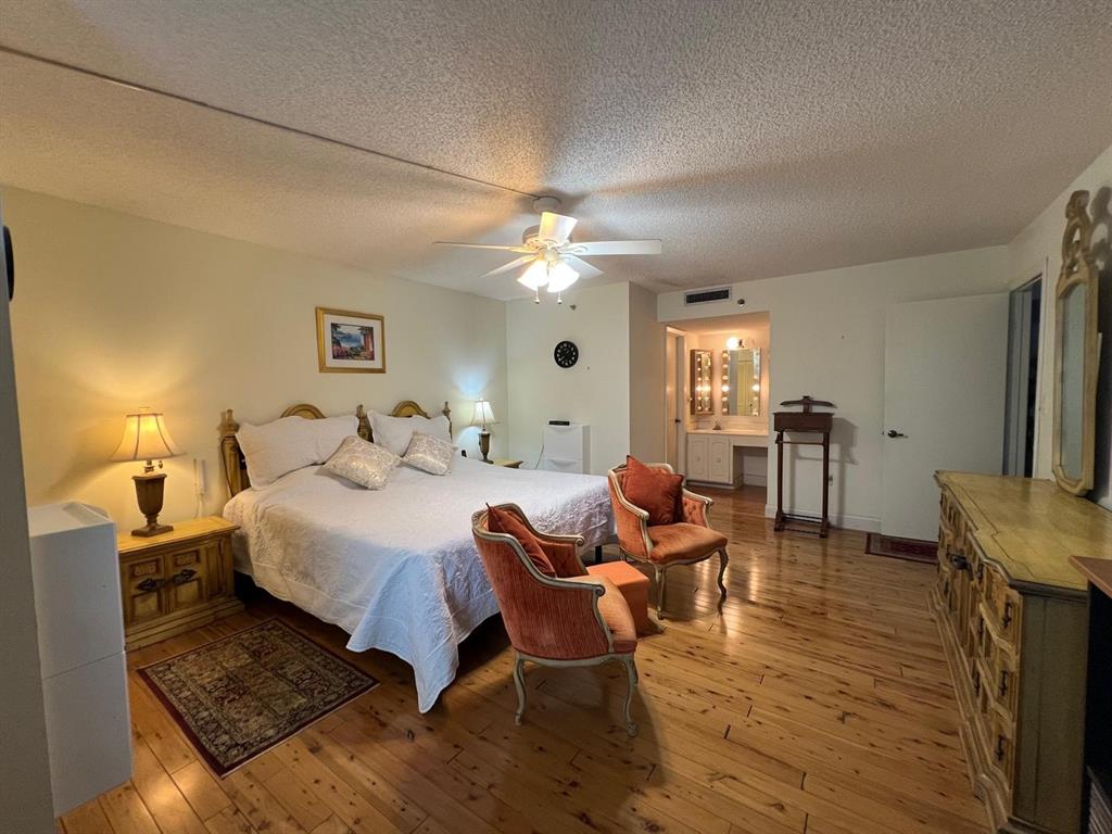 3910 Inverrary Boulevard, Unit 301B Lauderhill, FL 33319 - Photo 16 of 44 a bedroom with furniture and a chandelier