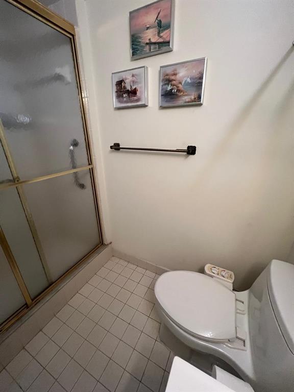 3910 Inverrary Boulevard, Unit 301B Lauderhill, FL 33319 - Photo 20 of 44 a bathroom with a toilet and a shower