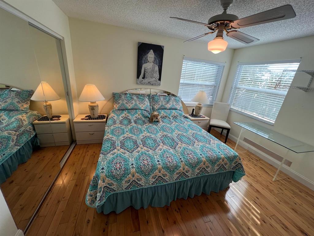 3910 Inverrary Boulevard, Unit 301B Lauderhill, FL 33319 - Photo 22 of 44 a bedroom with a bed mirror and window