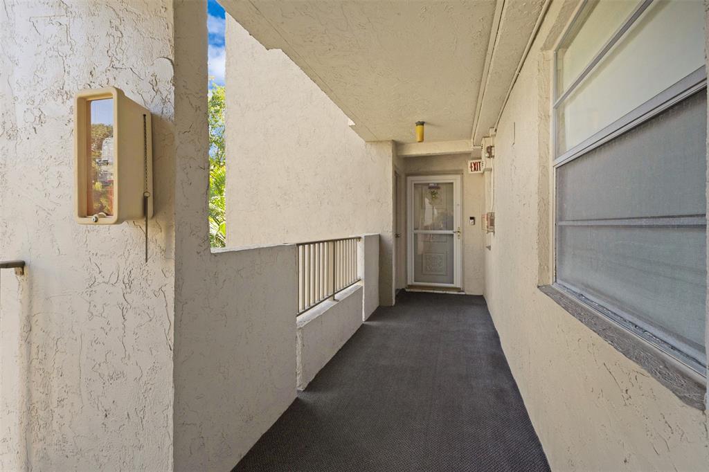 3910 Inverrary Boulevard, Unit 301B Lauderhill, FL 33319 - Photo 30 of 44 a view of a hallway with wooden floor and staircase