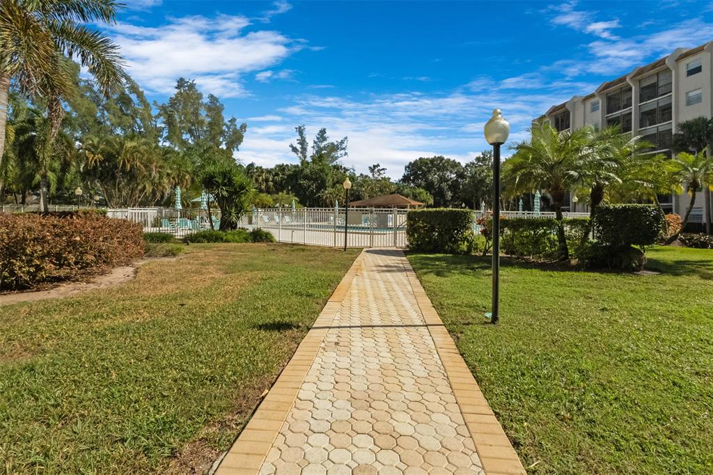 3910 Inverrary Boulevard, Unit 301B Lauderhill, FL 33319 - Photo 31 of 44 a view of swimming pool with a yard