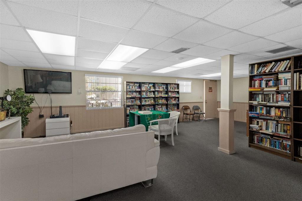 3910 Inverrary Boulevard, Unit 301B Lauderhill, FL 33319 - Photo 40 of 44 a living room with furniture a flat screen tv and a bookshelf