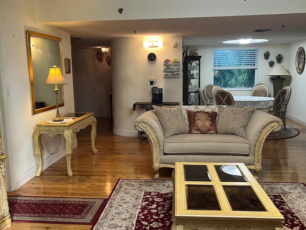 3910 Inverrary Boulevard, Unit 301B Lauderhill, FL 33319 - Photo 6 of 44 a living room with furniture and a rug