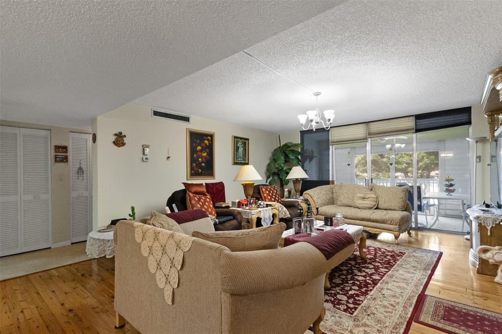 3910 Inverrary Boulevard, Unit 301B Lauderhill, FL 33319 - Photo 7 of 44 a living room with furniture and a large window
