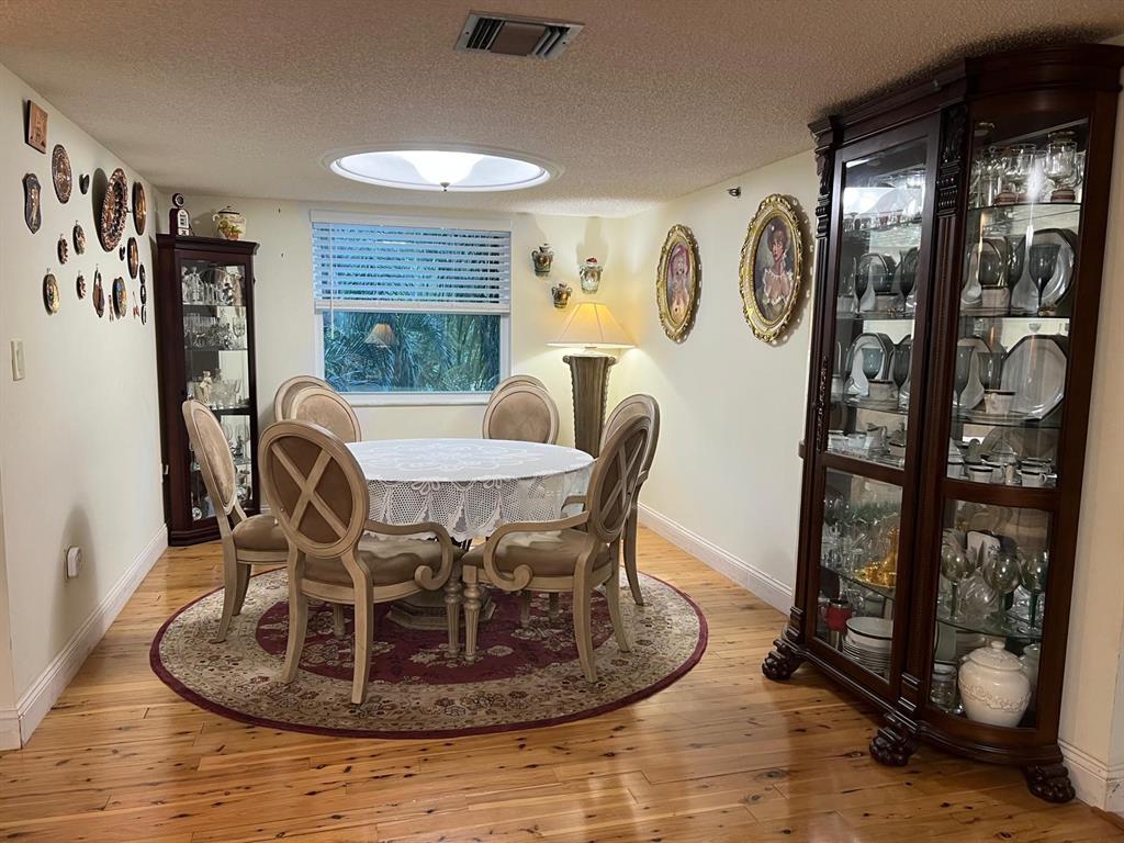 3910 Inverrary Boulevard, Unit 301B Lauderhill, FL 33319 - Photo 8 of 44 a dining room with furniture and window