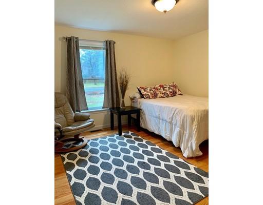 21 Middle Road Amesbury, MA 01913 - Photo 10 of 21 a bedroom with a bed and a window