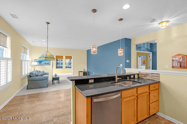 a kitchen with granite countertop a sink and a stove