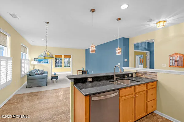a kitchen with granite countertop a sink and a stove