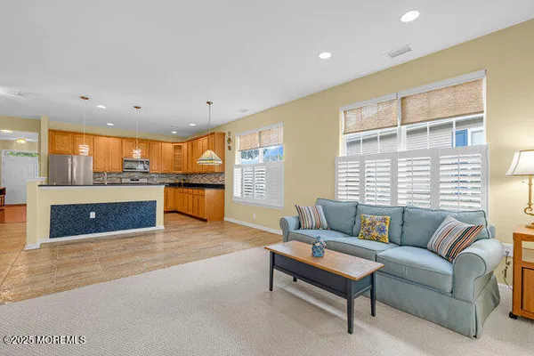 a living room with furniture and kitchen view