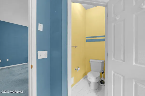 a bathroom with a granite countertop toilet and a sink