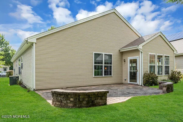 a front view of a house with a yard and green space