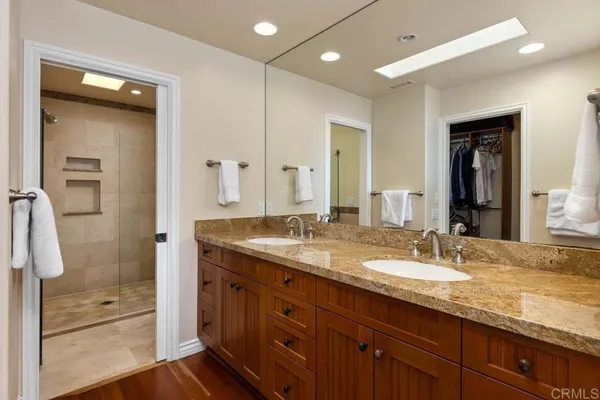 a bathroom with a granite countertop sink mirror and double