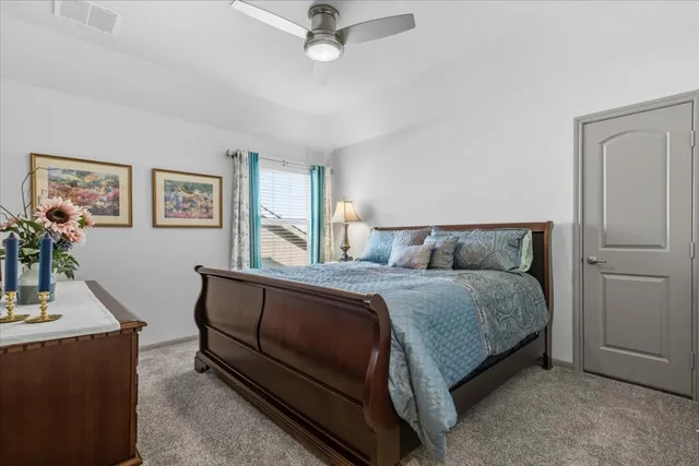 a spacious bedroom with a bed and a desk