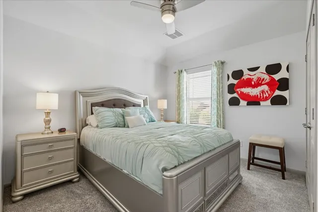 a bedroom with a bed and a dresser