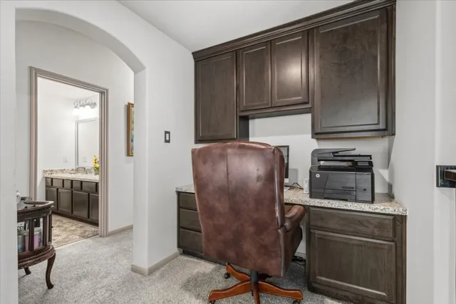 a kitchen with a refrigerator and a stove top oven