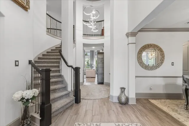 a view of a hallway with wooden floor and entryway