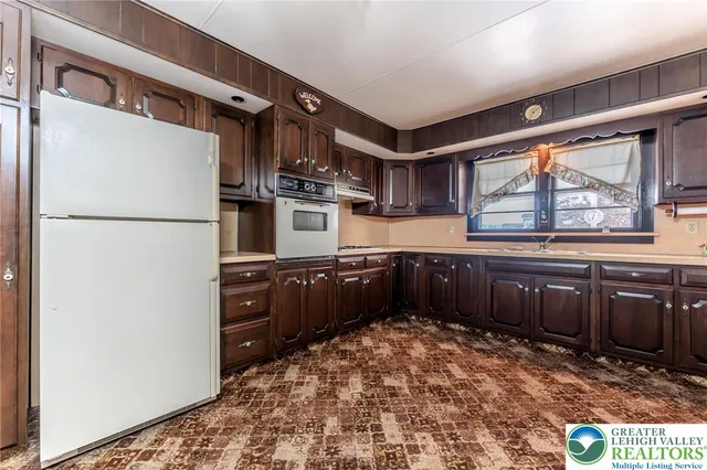 a kitchen with stainless steel appliances granite countertop a refrigerator and cabinets