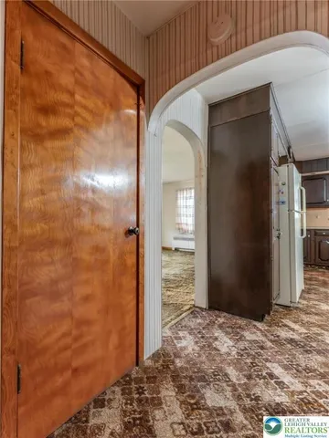 an empty room with fan and a chandelier fan