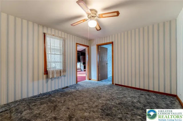 a bed room with a bed and a mirror